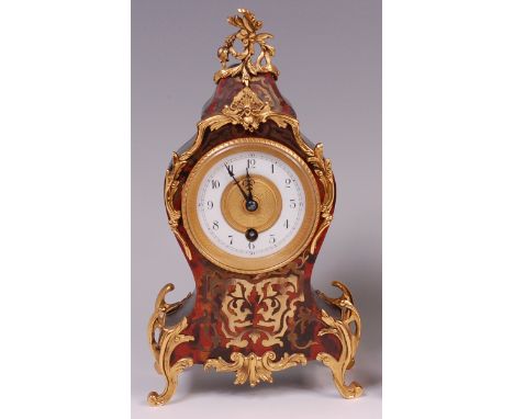 A late 19th century red boulle and gilt metal balloon shaped mantel clock, in the Louis XV manner, having a white enamel turn