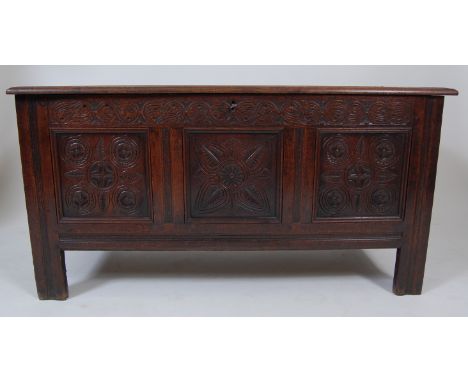 A circa 1700 joined oak three panel coffer, the rising cover on loop hinges and opening to reveal candle-box fitted interior,