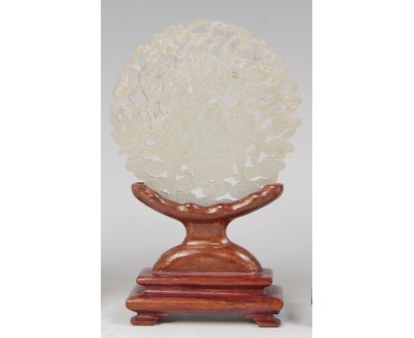 A Chinese pale celadon jade carving of a figure upon mythical beast, double-sided and carved in the round, on wooden stand, d