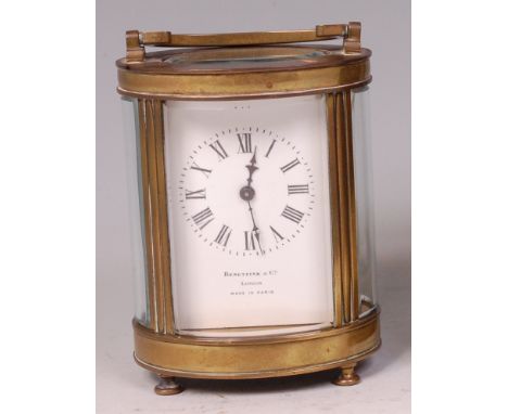 A circa 1900 brass carriage clock, of barrel shape, the white enamel dial signed by the London retailer Benetfink & Co, the c