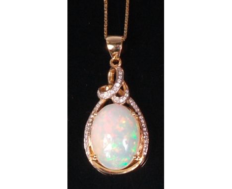 A modern 14ct yellow gold opal and diamond point set pendant, the four claw set cabochon opal weighing approx 4.5ct, in a dia