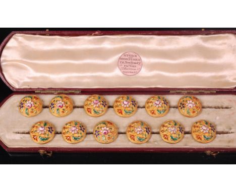 A cased set of twelve early Victorian yellow metal and finely enamelled dress buttons, retailed by Storr & Mortimer, in fitte