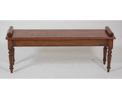 A Victorian style oak window seat, with scroll ends, raised on ring turned and tapering supports, w.126cm, seat h.46cm, d.32c