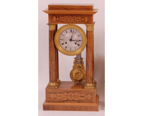 A late 19th century rosewood and inlaid portico clock, having an engine turned silvered dial with Roman numerals, twin windin
