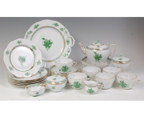 A modern Herend of Hungary porcelain six-place setting teaset, decorated with trailing flowers and leaves in green on a baske