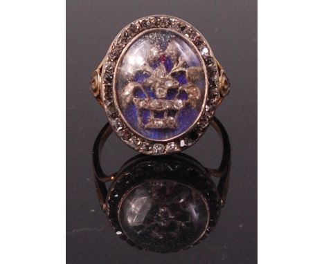 A 19th century yellow metal diamond and enamel set ring, arranged as a basket of flowers set with small rough cut diamonds un