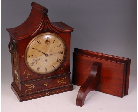 A Regency mahogany and brass inlaid bracket clock, with original wall bracket, the clock having an indistinctly signed convex
