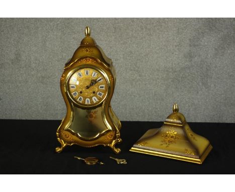 A 20th century Le Castel Swiss lacquered green and gold bracket clock, with brass pendulum and key for winding and wall mount