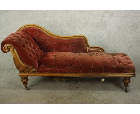 An 19th century mahogany framed chaise longue, with scroll arm and button and quilted style orange seats and arms, raised on 
