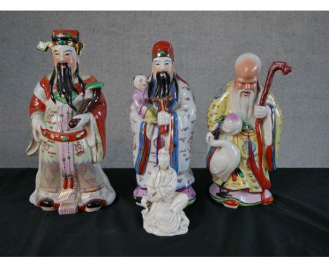 Three Chinese polychrome porcelain Immortal figures, together a Chinese Blanc de Chine porcelain figure of Guan Yin. H.33 W.1