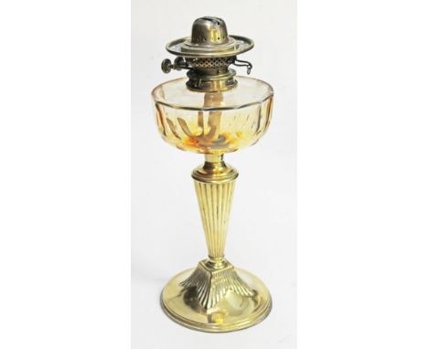 A brass oil lamp with amber cut glass well, height 42cm. Condition - slightly bent, label missing off brass fitting, general 