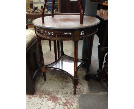 An Edwardian mahogany occasional table with pierced frieze and column legs. H69cm Diam. 61cm.