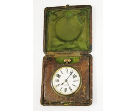 An 8 day alarm clock within crocodile skin case.