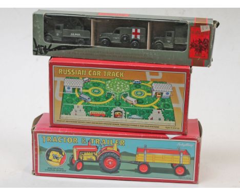 Three boxed modesl comprising a Russian Car Track, a Guadalcanal US Marines vehicle set and a Schylling Tractor & Trailer.