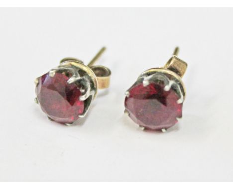 A pair of ruby stud earrings, each stone approx. 1.50 carats, gross wt. 1.9g.
