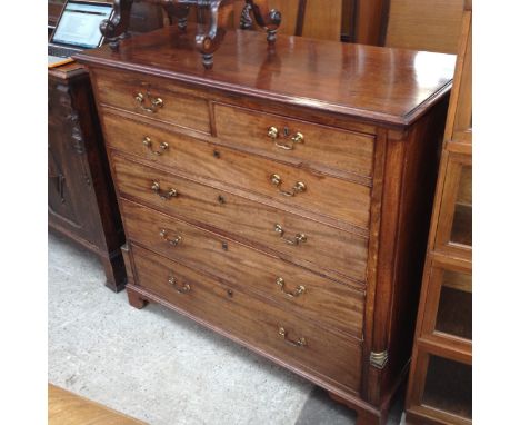 A Georgian mahoagny chest of drawers with quarter cut brass mounted columns, brass handles and bracket feet. W122.5cm D56cm H