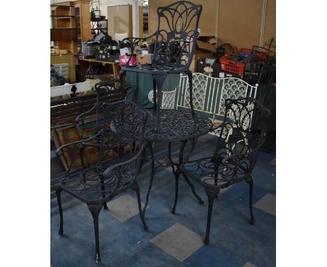 A Black Painted Cast Metal Garden Patio Set to Comprise Four Chairs and Table 