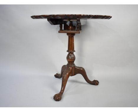 A Reproduction Mahogany Tripod Table with Circular Pie Crust Top, Bird Cage Support and Carved Tripod with Claw and Ball Feet