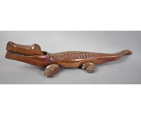 An Enamelled Metal Novelty Nutcracker in the Form of a Crocodile, 36cm Long 