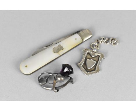 A Silver Bladed and Mother of Pearl Fruit Knife (Condition Issues) Together with a Silver Fob and a Brooch with Purple Stone 