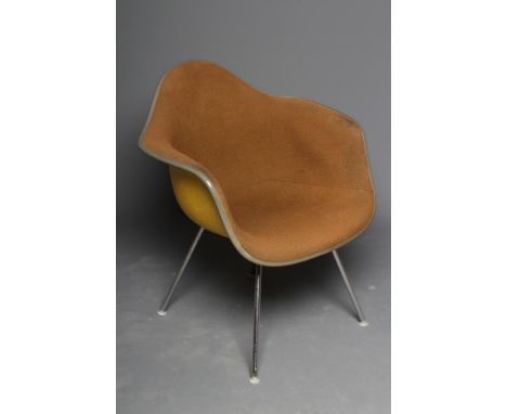 A CHARLES & RAY EAMES FOR HERMAN MILLER SHELL CHAIR in yellow fibre glass with brown woven cushion, on chrome plated tubular 