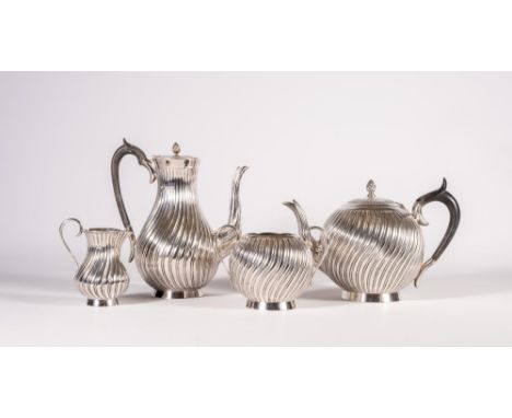 A COMPOSITE VICTORIAN SILVER FOUR PIECE TEA AND COFFEE SERVICE, maker Edward Hutton, London 1886/9, of wrythen fluted globula