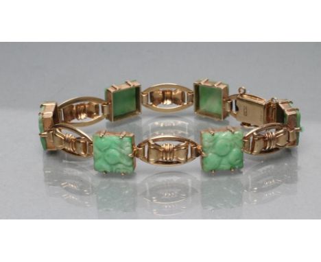 A JADE BRACELET, the six fruit carved square panels with 9ct gold open bow links between, Birmingham 1960 (Est. plus 21% prem