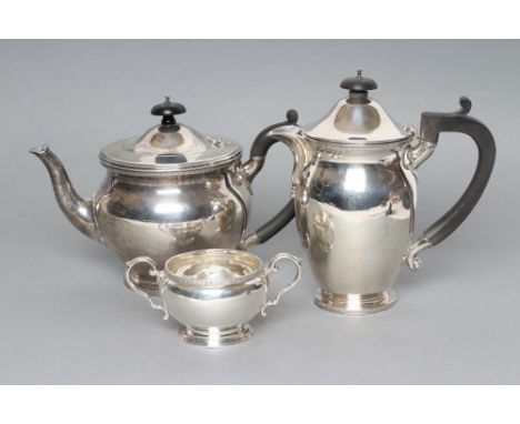 A SILVER TEA AND COFFEE POT, maker Manoah Rhodes, London 1924, of baluster form with cast and applied stiff leaf rims, earred