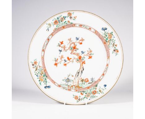 A CHINESE PORCELAIN PLATE of plain circular form, painted in famille verte enamels with a central roundel enclosing a floweri