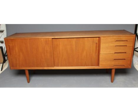 A NILS JONSSON FOR TROEDS TEAK TRENTO SIDEBOARD, with two sliding doors enclosing shelving flanked by a bank of four drawers 