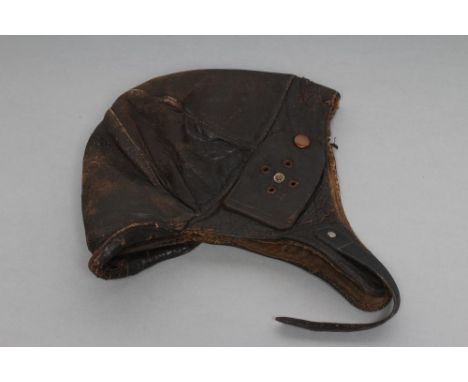 A GERMAN FIRST WORLD WAR LEATHER FLYING HELMET with small peak, ear flaps and buckle fastened chin strap (Est. plus 21% premi