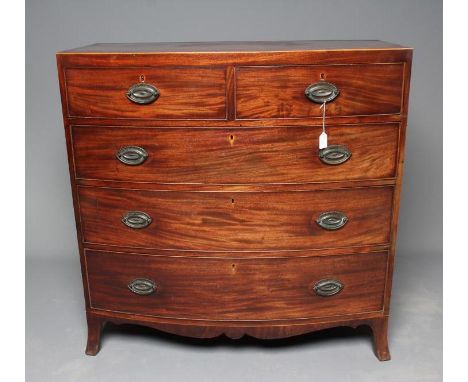A REGENCY MAHOGANY BOWED CHEST of two short and three long cockbeaded drawers, later brass oval drop handles, caddy top with 