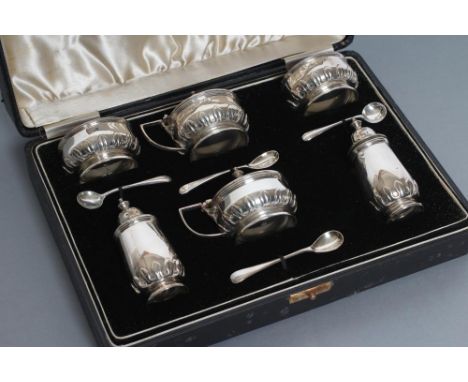 A SILVER COMPOSITE SIX PIECE CRUET, maker Adie Bros., Birmingham 1935, 1938 and 1942 and Chester 1940 (one pepperette), with 