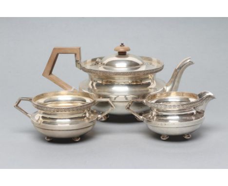 AN ART DECO THREE PIECE SILVER TEA SERVICE, maker Pearce & Sons, Sheffield 1927, of squat cylindrical form raised upon four b