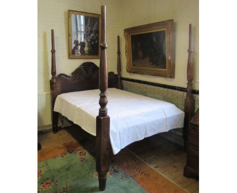 A JAMAICAN HARDWOOD "WATERFALL" FOUR POSTER BED, 19th century, the baluster turned tapering posts enclosing typically carved 