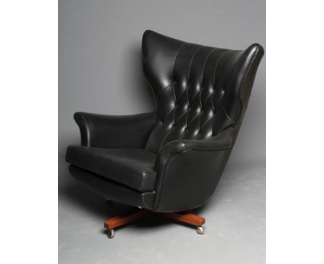 A G PLAN MODEL 6250 "BLOFELD" WING ARMCHAIR, designed by Paul Conti, button upholstered in black leatherette on a swivel X fo