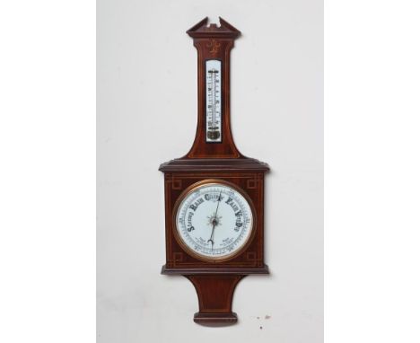 AN EDWARDIAN MAHOGANY ANEROID BAROMETER, the white enamel dial with Roman numerals, the crossbanded and strung square case wi