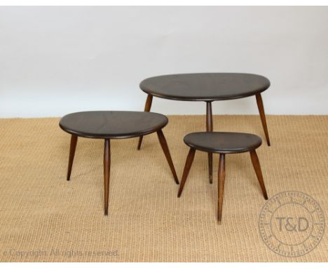 A nest of three Ercol dark wood pebble tables, all with labels to the underside, the largest 40cm H x 65cm W x 44cm D, (3) CO