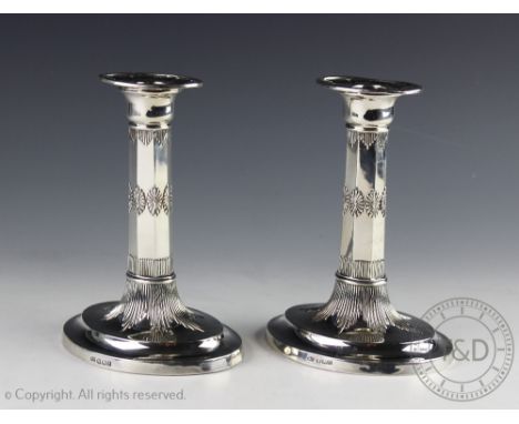 A pair of late Victorian silver candlesticks, Harrison Brothers and Howson, Sheffield 1898, of oval form with fluted detailin