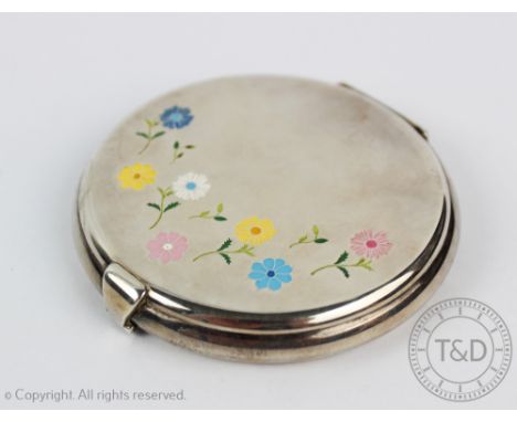 An American sterling silver and enamel ladies powder compact, the circular compact enamelled to the cover with flower head bl