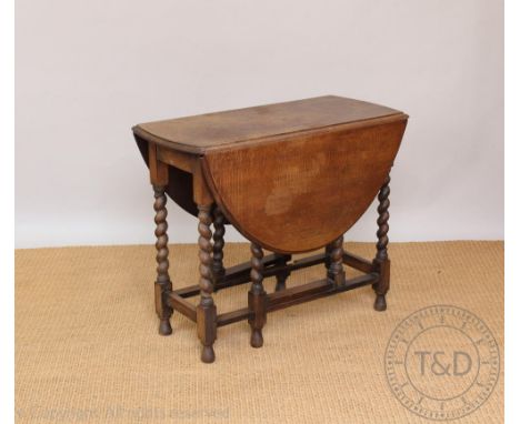 A 1920's oak gate leg table, on barley twist legs, 73cm H x 91cm H x 41cm D (sized when closed)