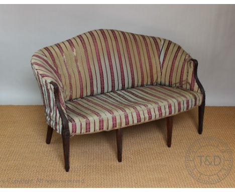 A late 19th century French Hepplewhite style carved mahogany salon sofa, of shaped serpentine form, with reeded arms, on reed