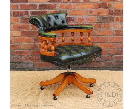 A green button back leather office swivel desk chair, 83cm