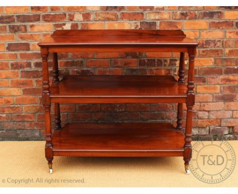 A late Victorian mahogany three tier buffet, each tier with a moulded edge and rounded corners, on turned uprights and fitted