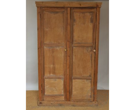 A pine two door livery cupboard, one door enclosing a shelf and two drawers, 190cm H x 114cm W x 49cm D