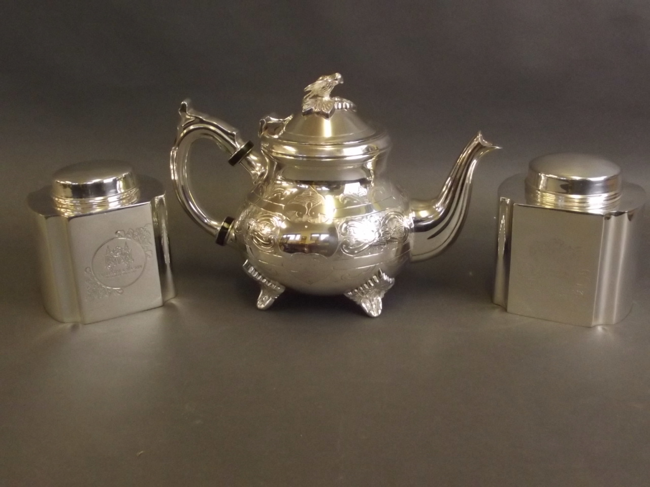 A Fortnum & Mason silver plated teapot, and a pair of tea caddies