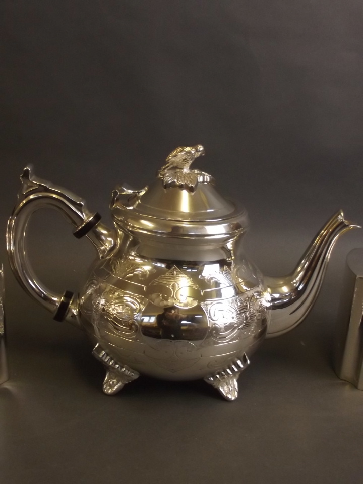 A Fortnum & Mason silver plated teapot, and a pair of tea caddies