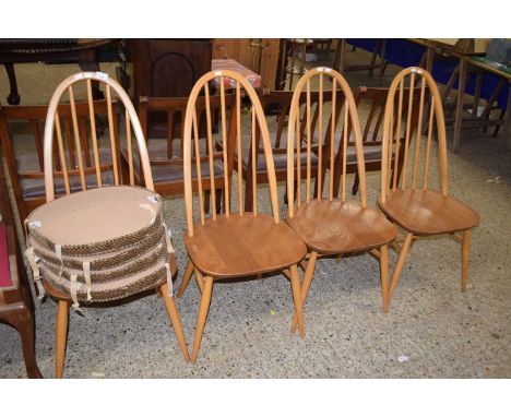 A set of four Ercol light elm stick back dining chairs