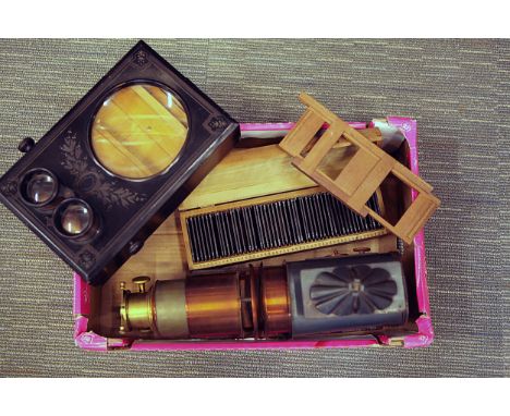 An Unmarked Graphoscope,together with a magic lantern, with original gas burner, complete with a set of commercial story slid