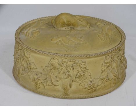 STONEWARE GAME PIE DISH in the style of Wedgwood, the lid with rabbit finial and further game in relief, the body with game b